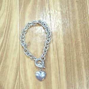Silver bracelet with heart shaped charm